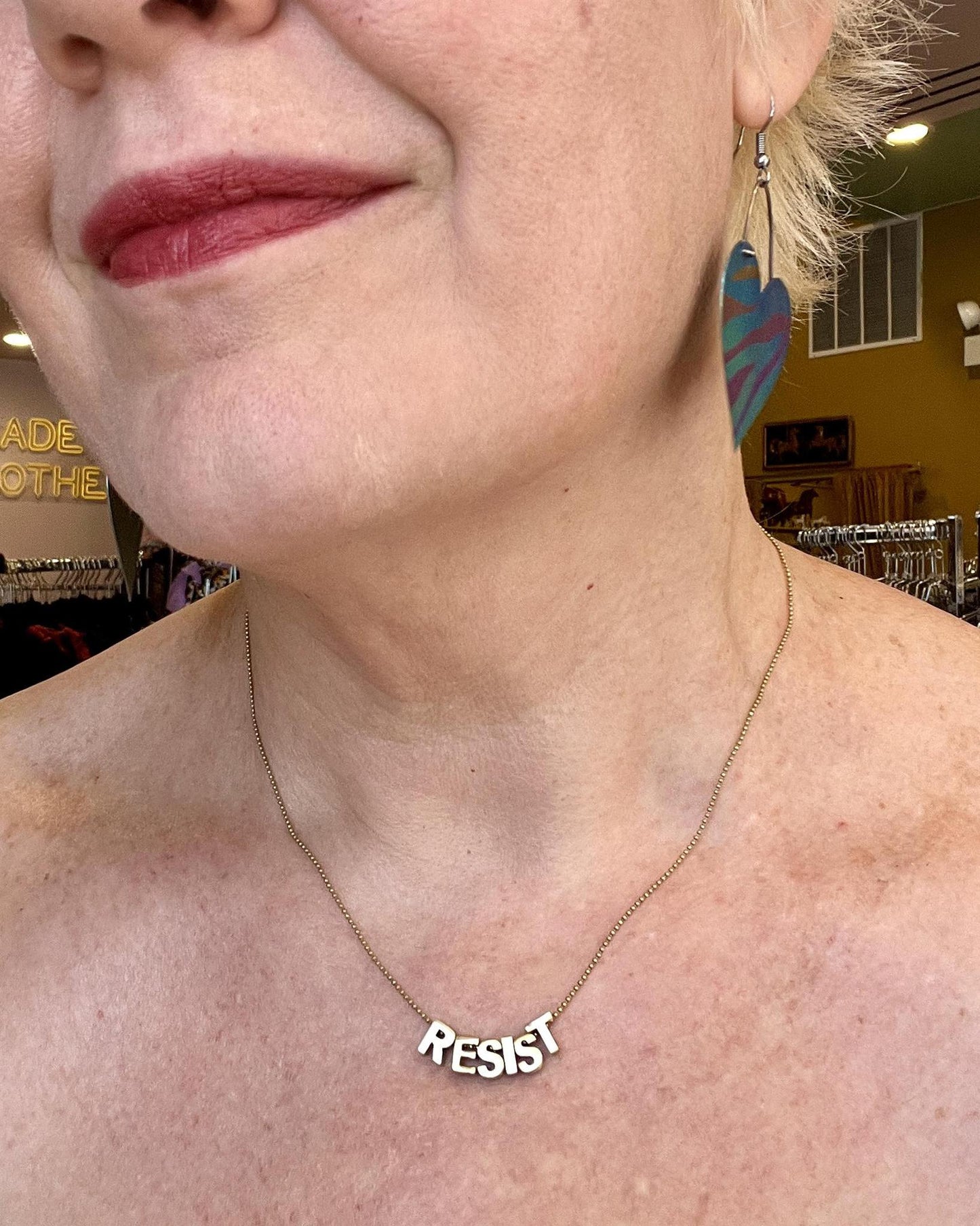 Sara Sela Brass RESIST Lettered Charm Necklace