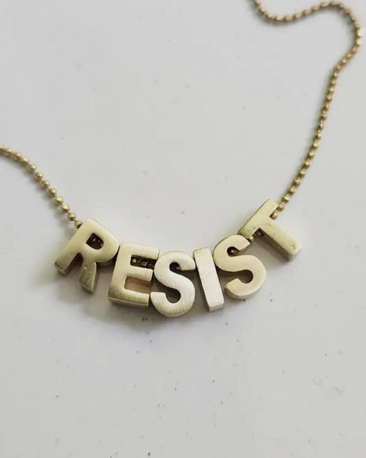 Sara Sela Brass RESIST Lettered Charm Necklace