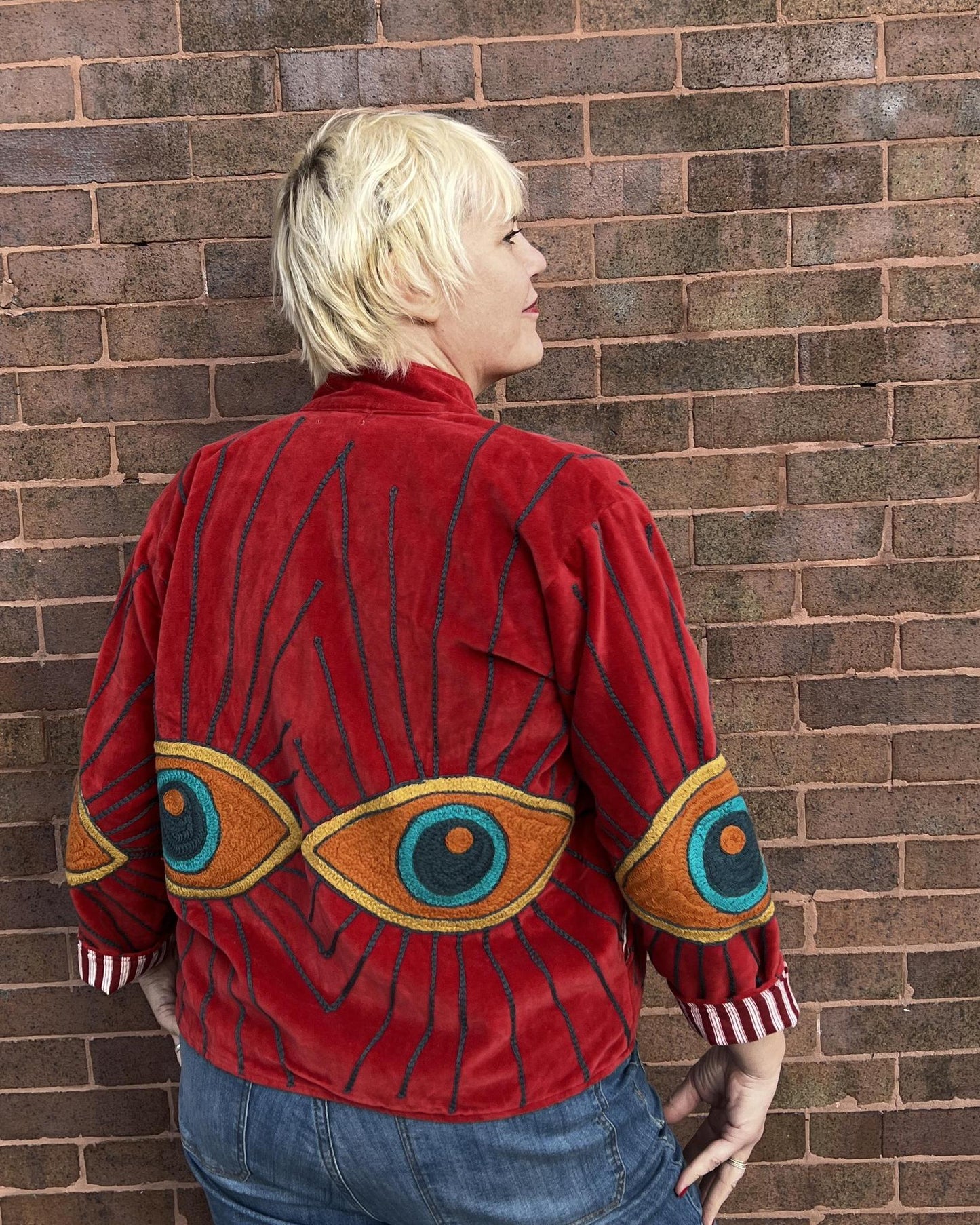Txtile Velvet Evil Eye Jacket in Cherry Red with Orange Eyes